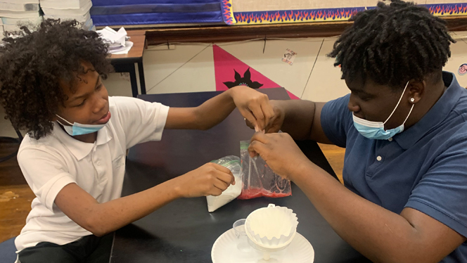 Emerson students working on a science experiment