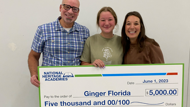 Ginger Florida holding her scholarship.