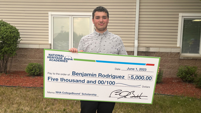 Benjamin Rodriguez holding scholarship.