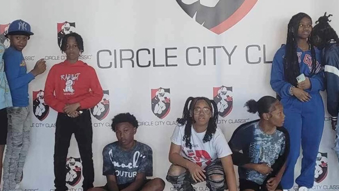 Scholars in front of Circle City Classic backdrop.