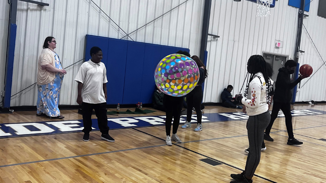 Scholars passing an inflatable ball.
