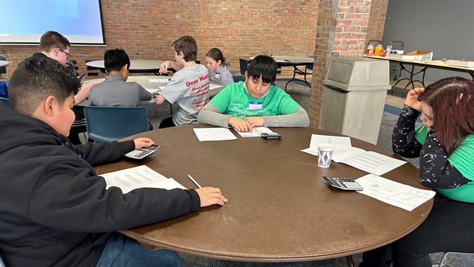 Students writing at tables.