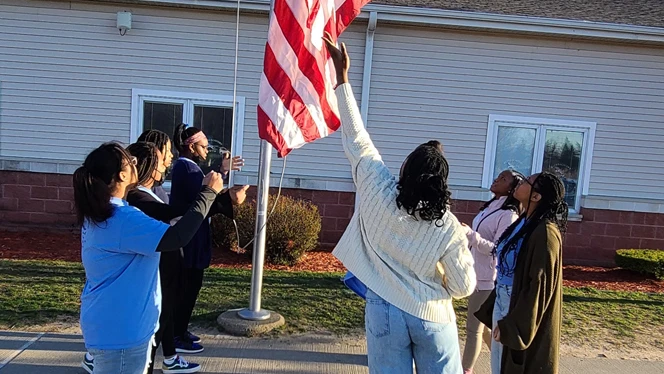 Students raising the flag. Students raising the flag.