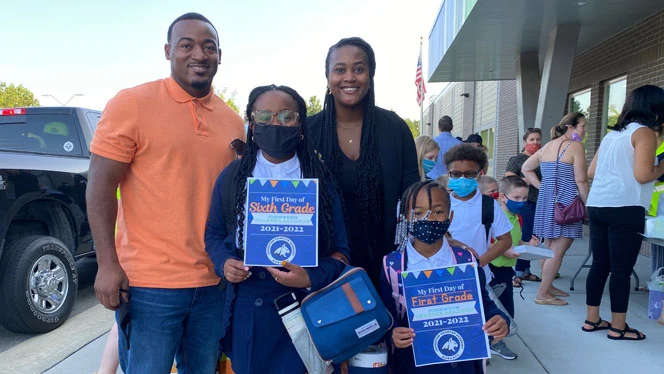 A family smiling on the first day of school. A family smiling on the first day of school.
