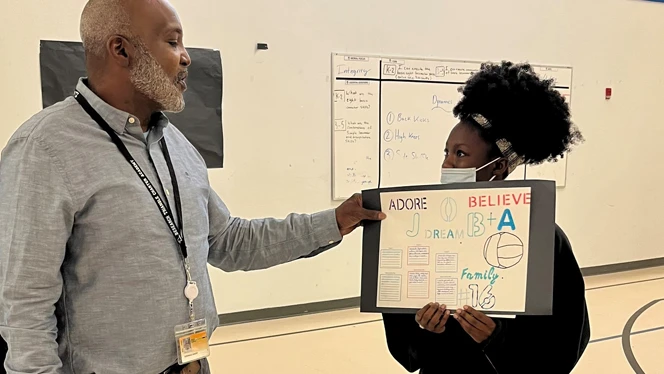 Student holding sign