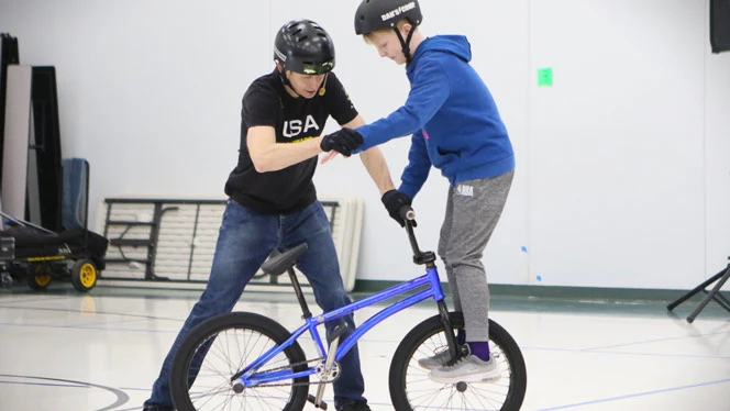 Wilhelm with student on bike