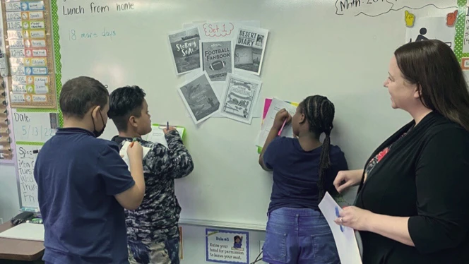 Kim Brisson works with students