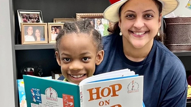 Principal Kinsey reading with a student