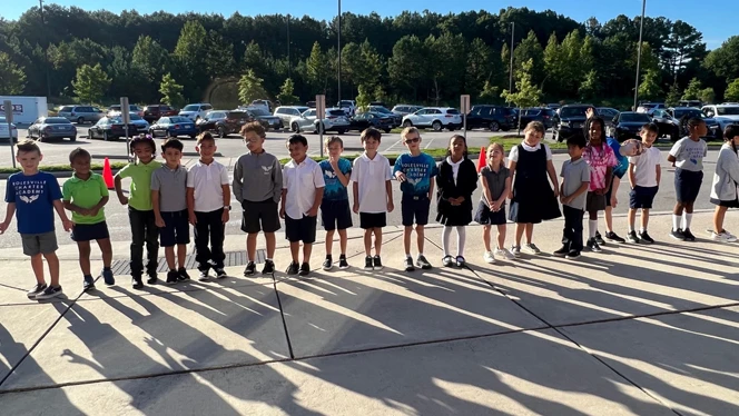 Students standing in a line outside.