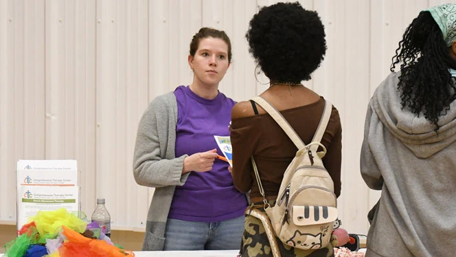 Wellspring Prep student talks with Comprehensive Therapy Center rep.