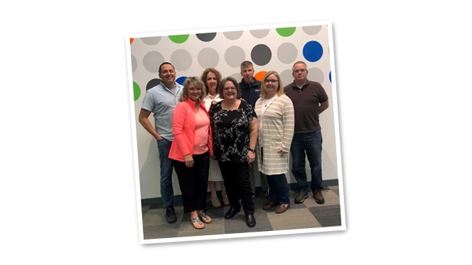 Mary McAlvey standing with her colleagues. Mary McAlvey standing with her colleagues.