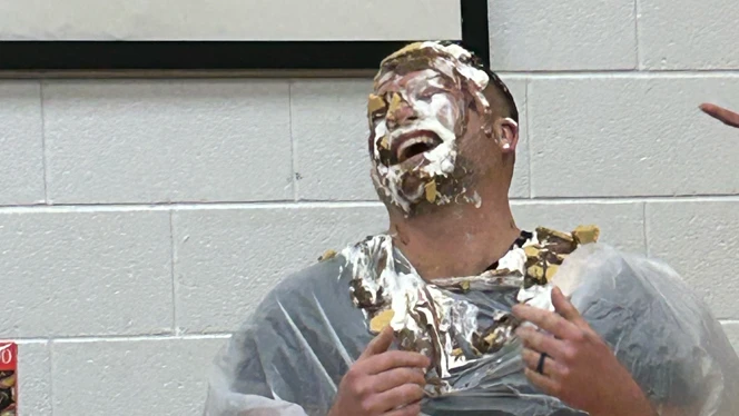 Staff member with pie on his face.