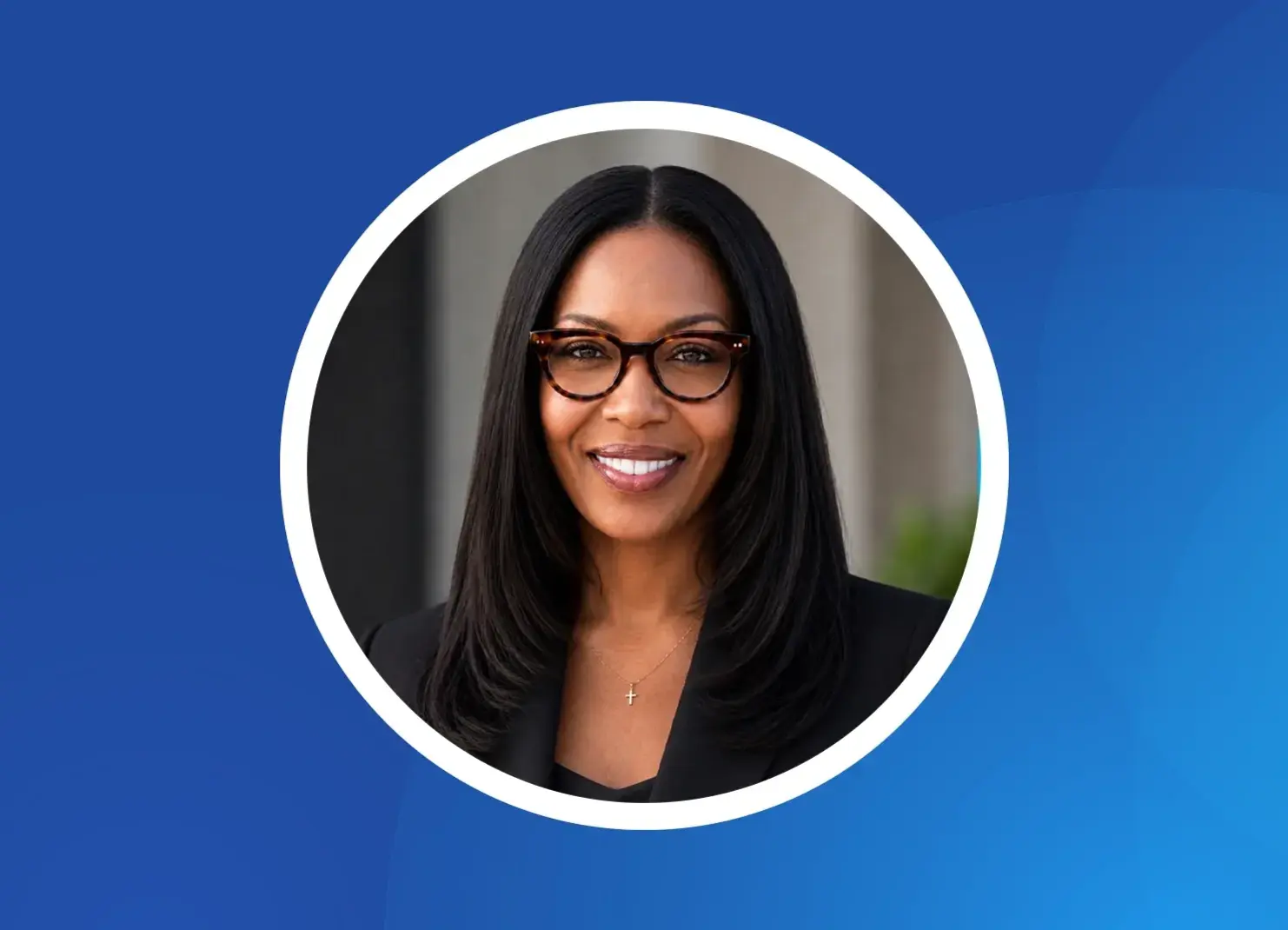 a woman wearing glasses and smiling
