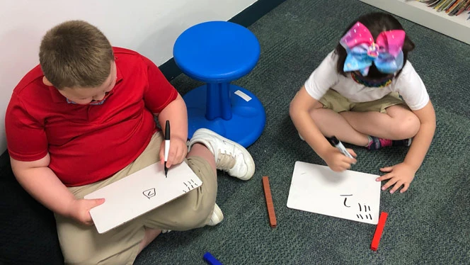 Children sitting on the floor learning. Children sitting on the floor learning.
