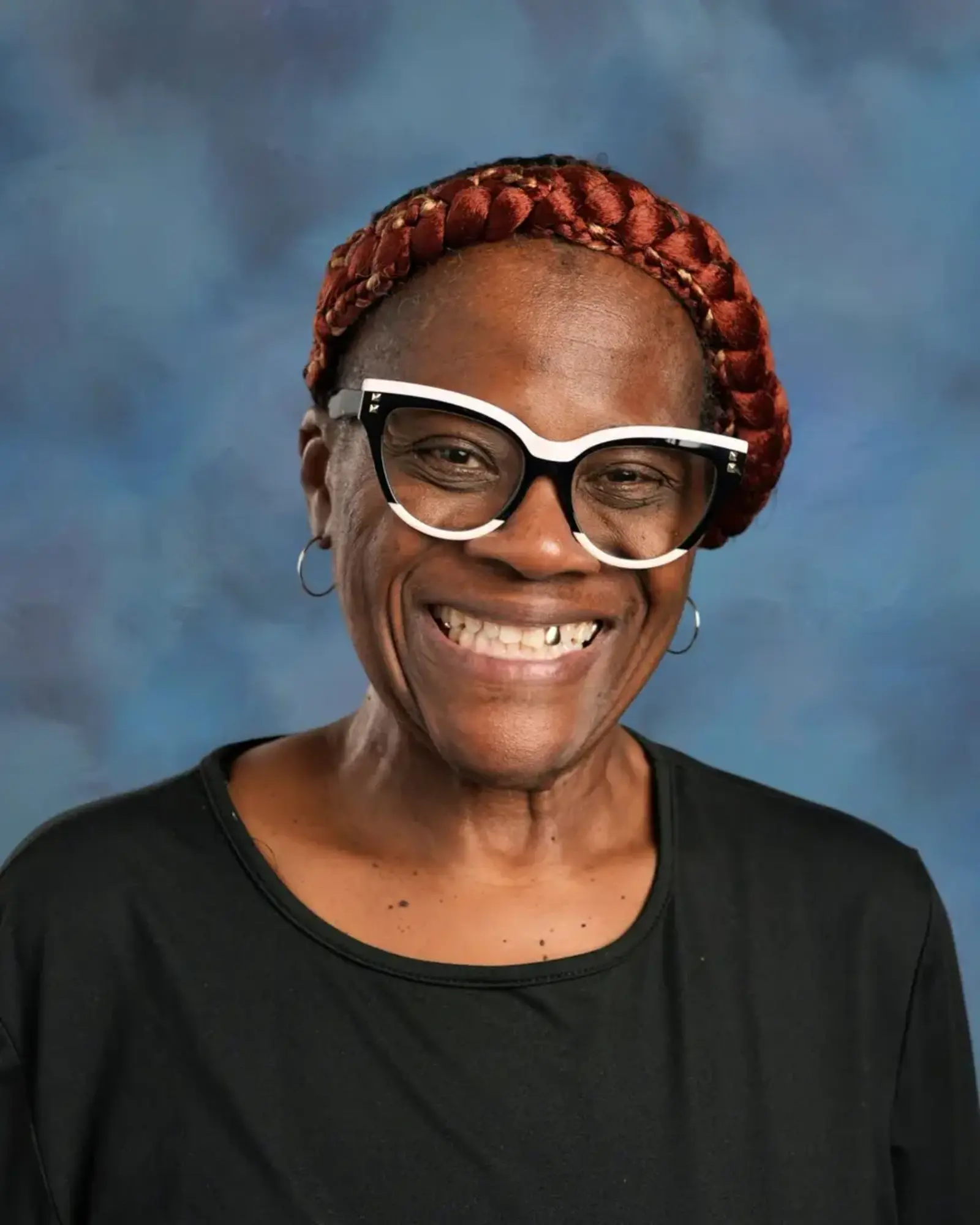 a woman wearing glasses and a black shirt