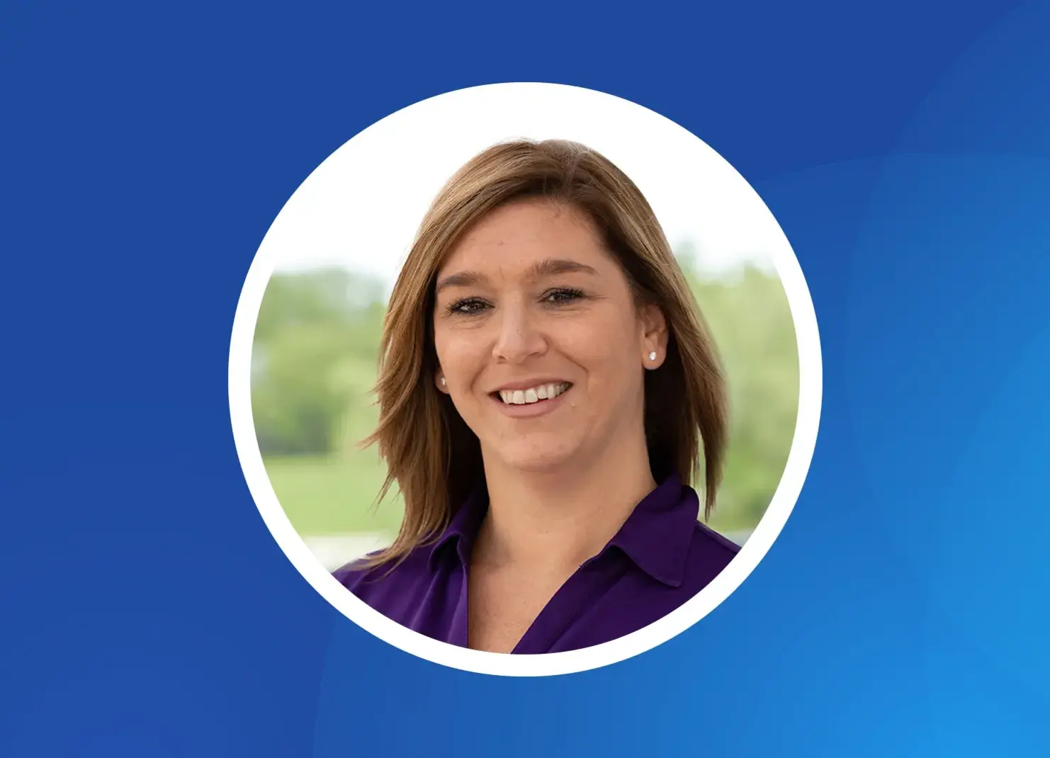 a woman smiling in a blue shirt