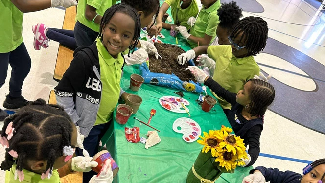 Detroit Enterprise students gardening.