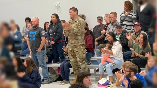 Veterans standing at assembly.