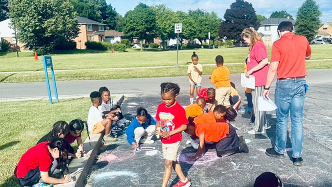 Buffalo United students creating chalk art.