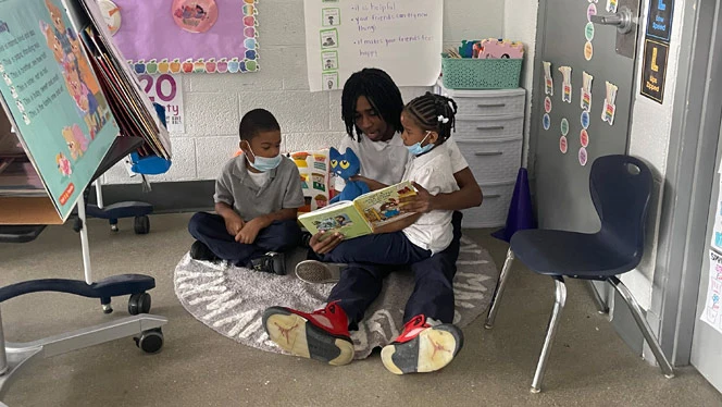 Center Line student reading to younger students.