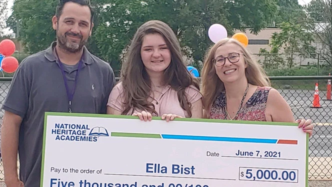 Ella Bist holding her scholarship. Ella Bist holding her scholarship.