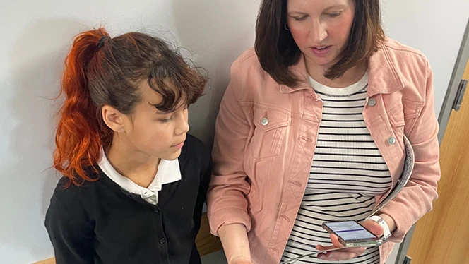 K-8 School in Waukesha: Fourth-grade student Hazel Pryor Corbine reads with a parent volunteer.