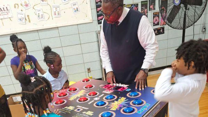 Teacher playing game with students.