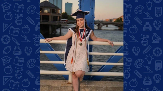 MacKenzie Piper on a bridge smiling. MacKenzie Piper on a bridge smiling.