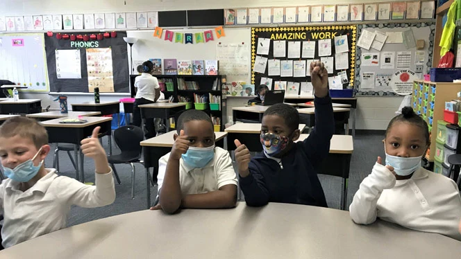 Students giving a thumbs up. Students giving a thumbs up.