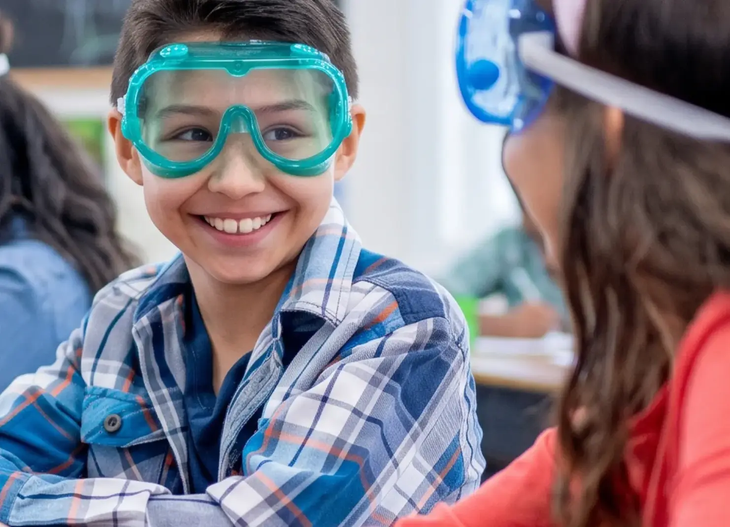 boy wearing goggles in science class
