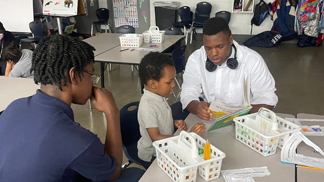 Center Line students help younger students with reading and math.