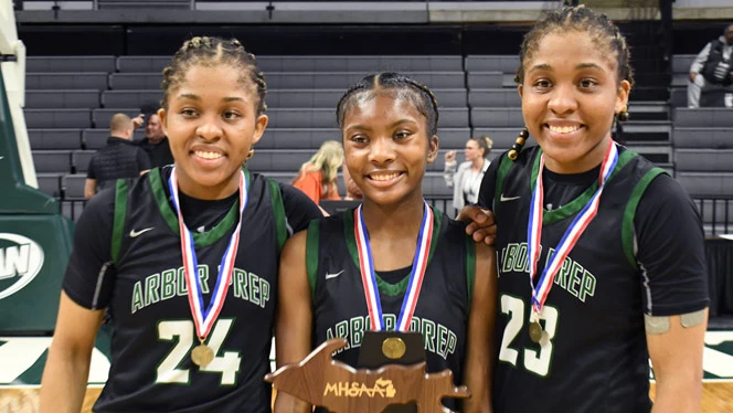 3 seniors pose with championship trophy