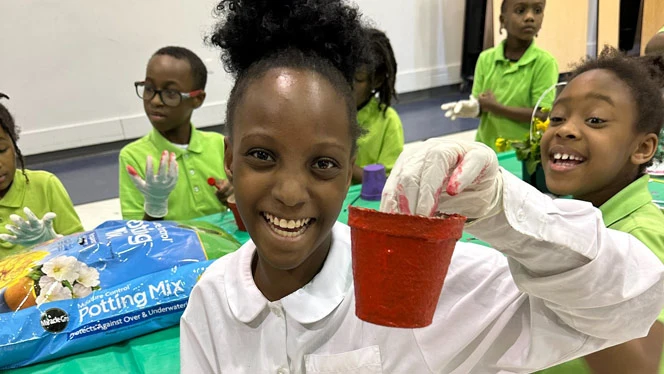 Detroit Enterprise student with her painted pot.