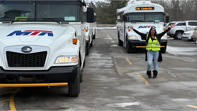 K-8 School in Flint: Linden Charter Academy's liaison poses with buses.