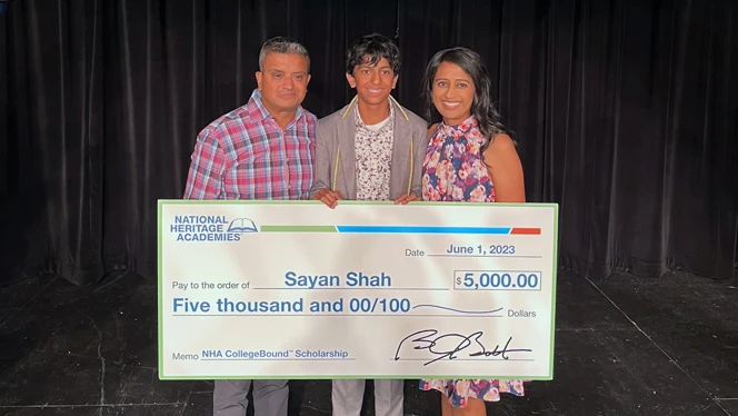 Sayan Shah standing with his family.