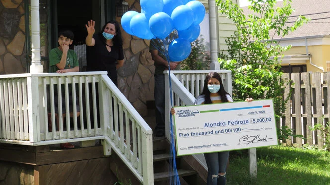 Alondra Pedroza holding up her scholarship. Alondra Pedroza holding up her scholarship.