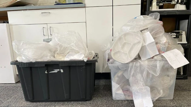 A tote full of filled trash bags. A tote full of filled trash bags.