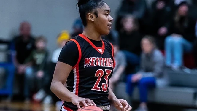 Kaylin Moorehead dribbling a basketball.