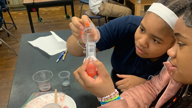 Emerson students working on a science experiment