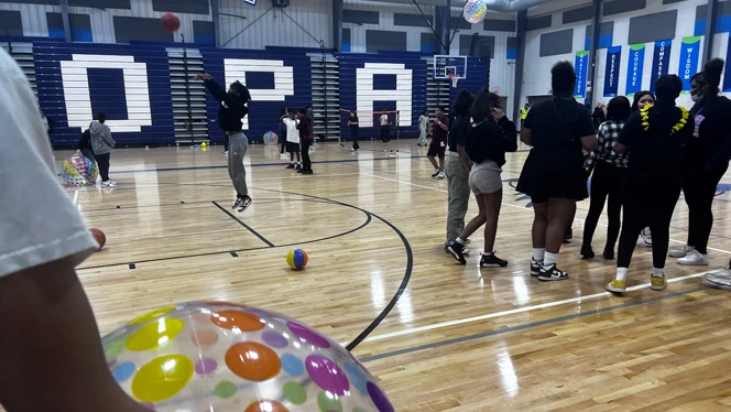 Scholars playing on the gym floor.