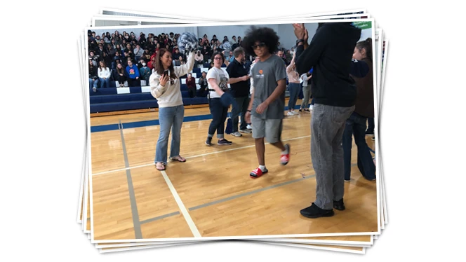 Students celebrating on gym floor.