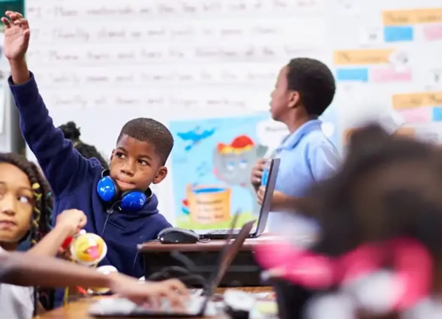 K-8 School in E. Cleveland: Student raising his hand in class.