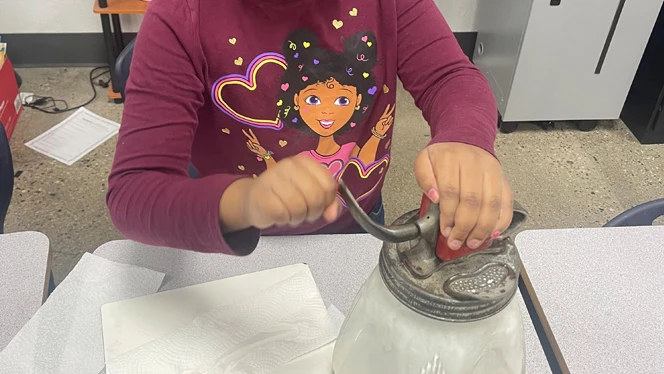 Center Line Prep student churning butter