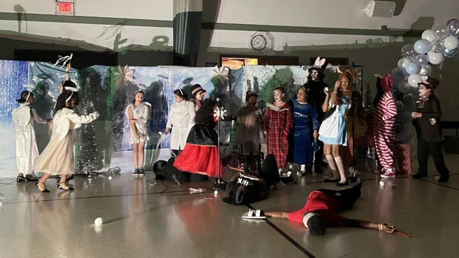 Many students on stage for the play. Many students on stage for the play.