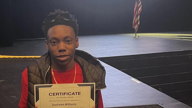 Aspire Charter Academy student Dashawn Williams with award.