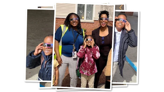 Metro students and staff wearing eclipse glasses.