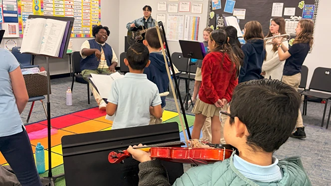 K-6 School in Commerce City: Capstone Academy music students welcomed members of a local band to sit with them during their rehearsal.
