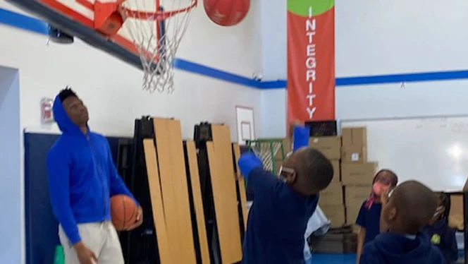 boys shooting basketball