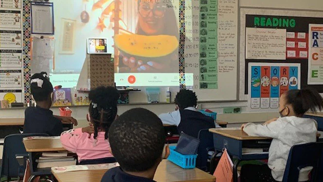 Detroit Merit students listen to guest reader