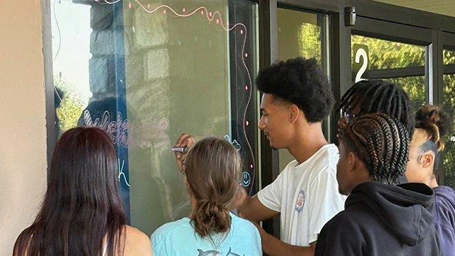 K-12 School in High Point: Phoenix Academy seniors decorate elementary and middle school buildings to help ease young scholars first day of school jitters.